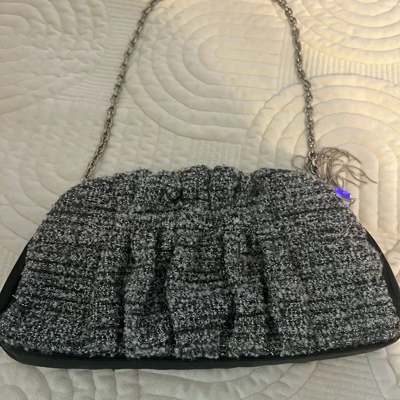 Shades of woven gray, and silver and black leather trim.Removable silver chain